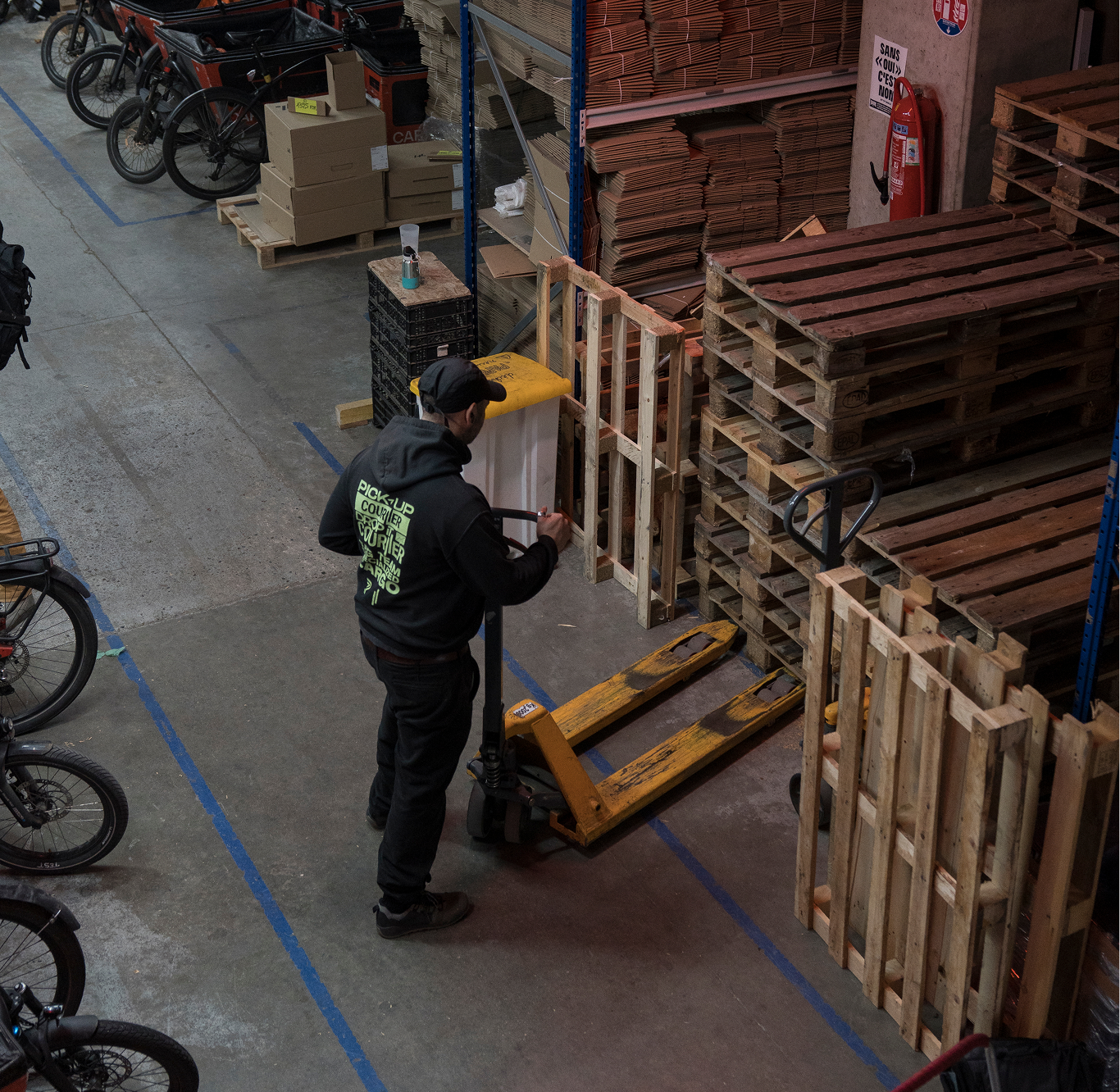 Une vue de l'entrepôt où un opérateur range une palette